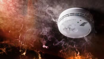 Smoke detector and fire alarm in action background