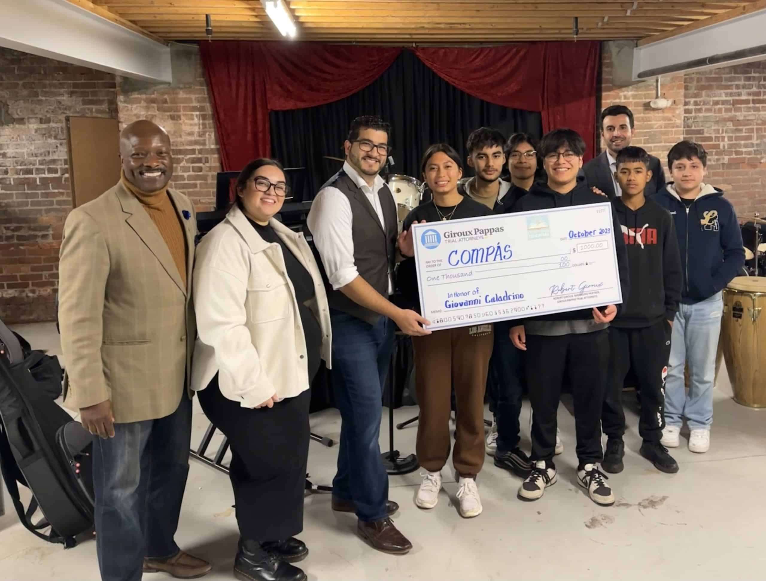 Music teacher, students, accept check from Giroux Pappas