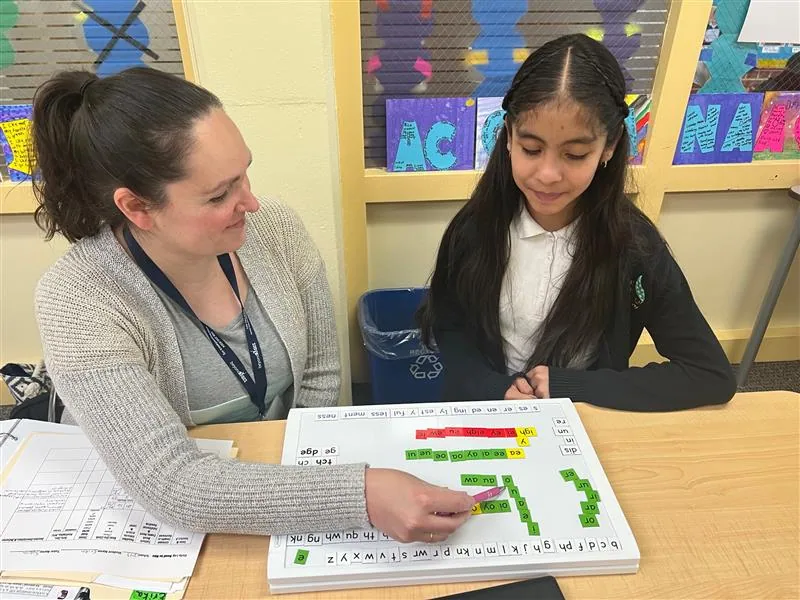 A teacher working with a student