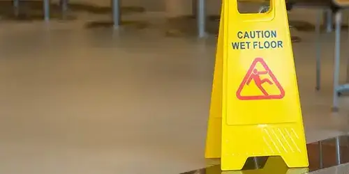 Wet floor sign at the entrance to a business