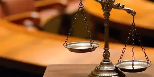 Metal scales of justice in a courtroom