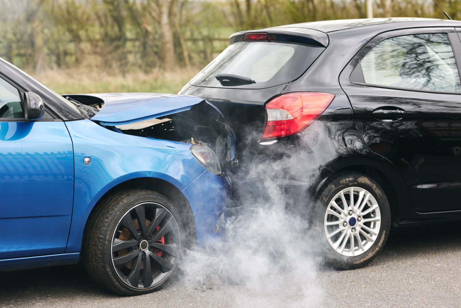 Two Damaged Cars Involved In Road Traffic Accident Showing Smoke