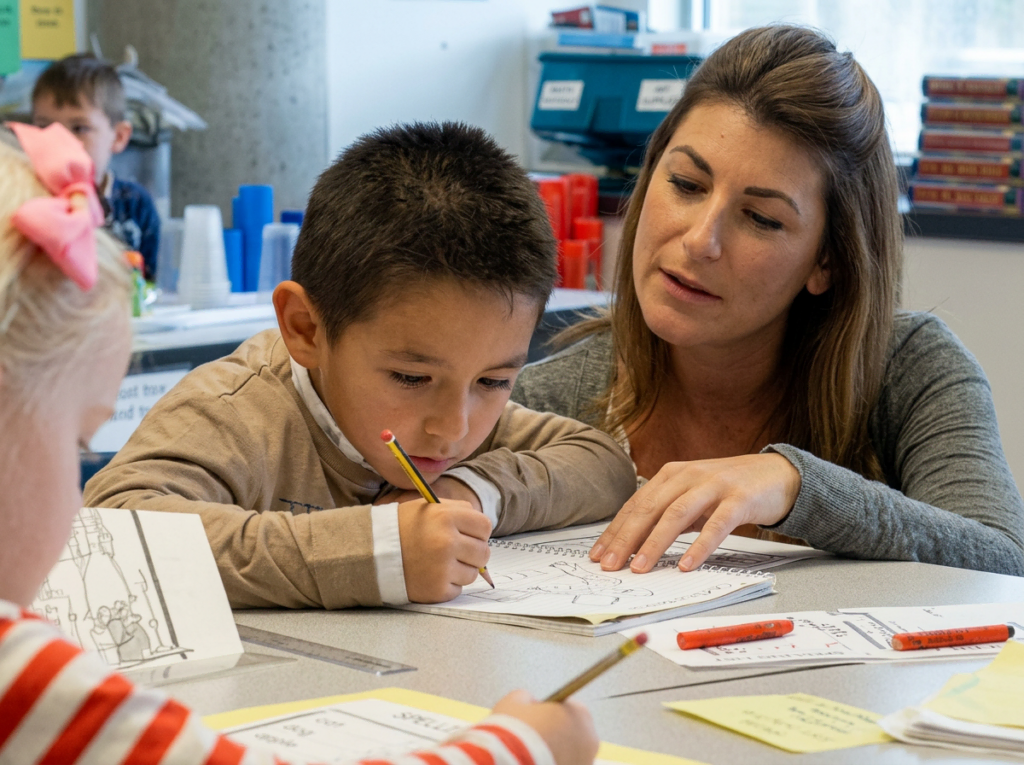Woman and kid writing