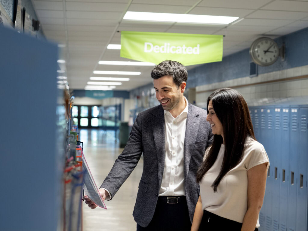 Evan Pappas and Principal Erin McIngvale of Hiagh Elementary Admire the Artwork on Students' Locker